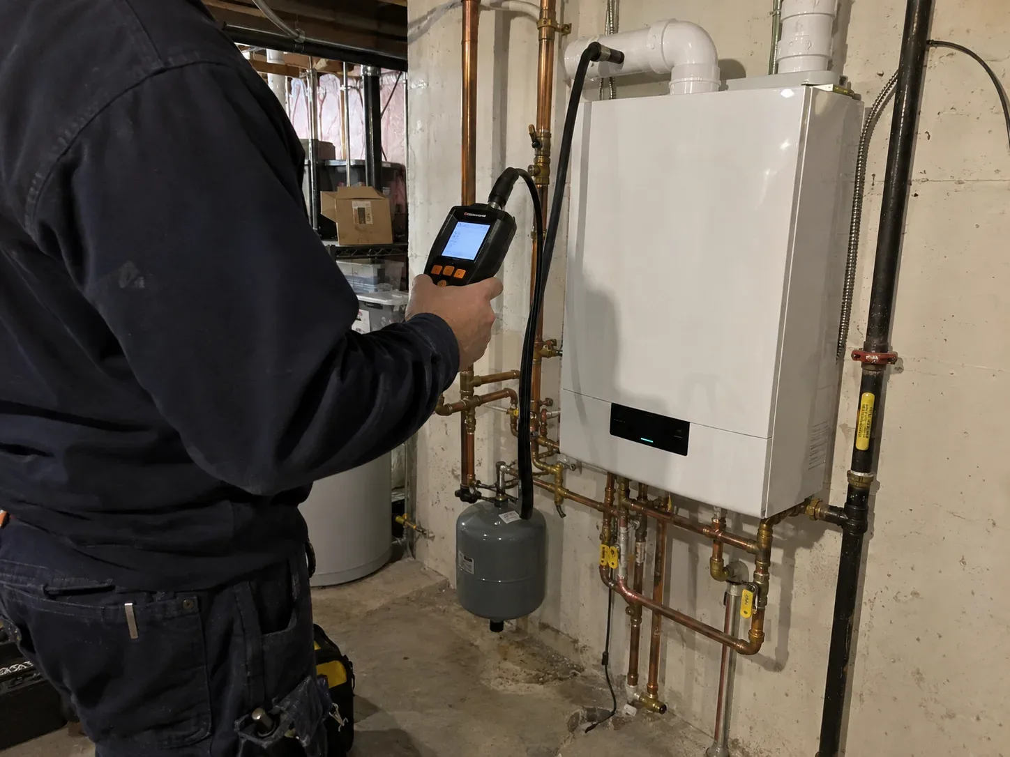 Technician checking boiler combustion with a professional analyser