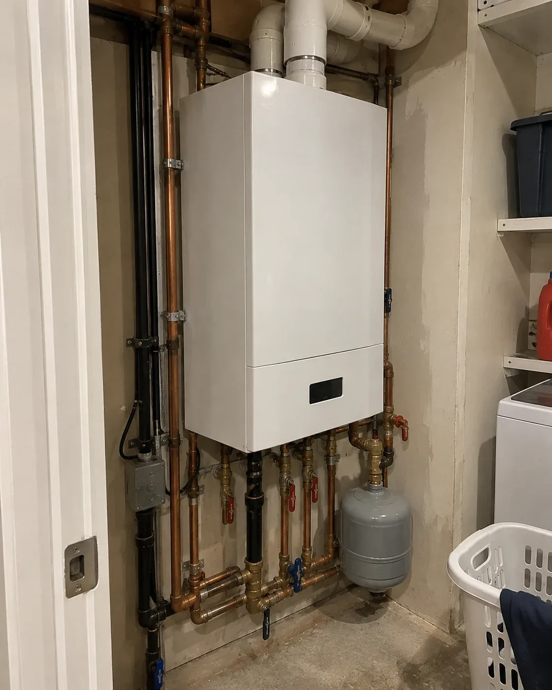Tankless combi boiler mounted on the wall of an Ottawa home